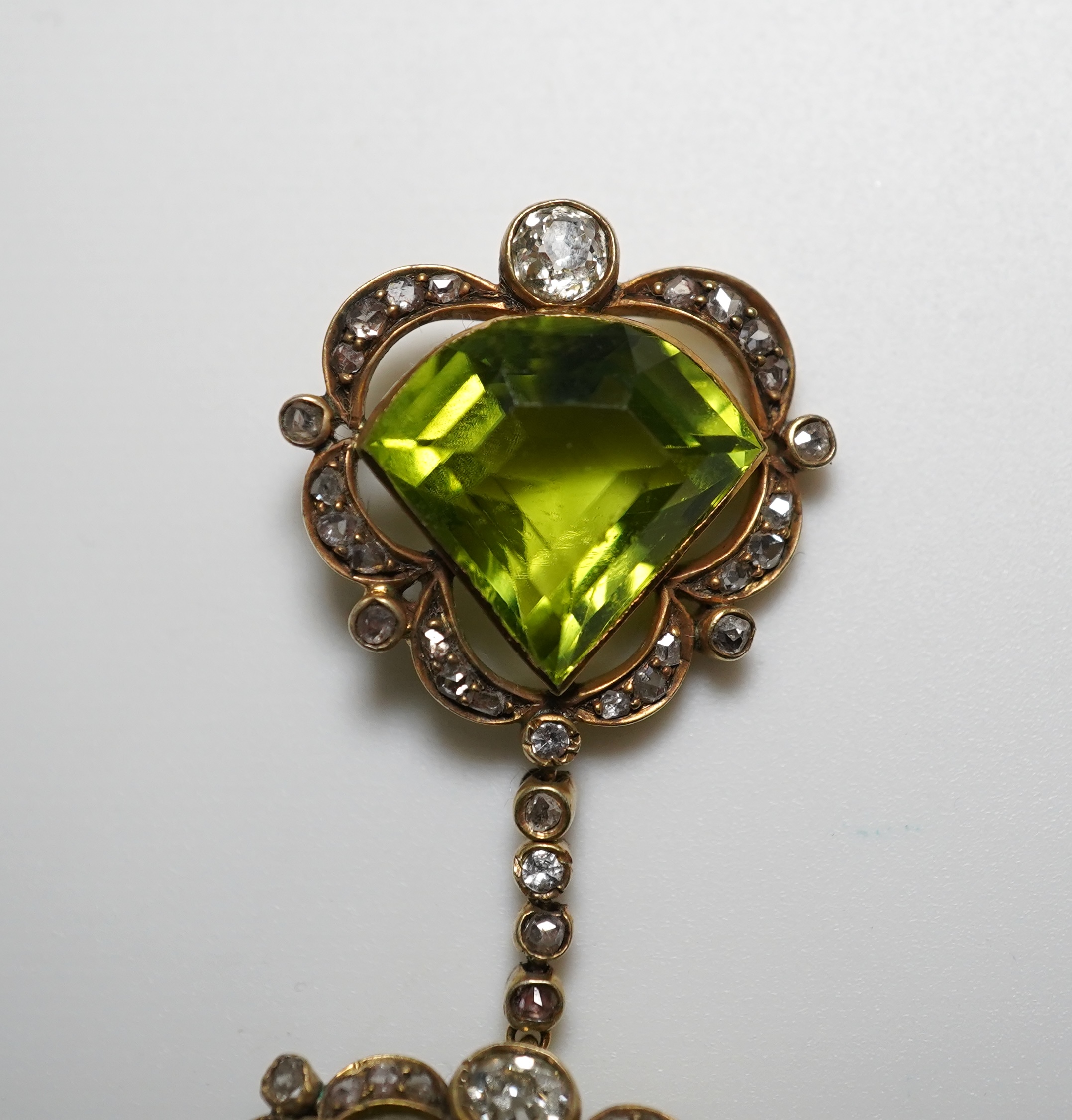 A peridot and diamond brooch, circa 1900